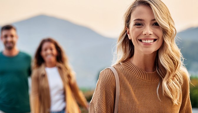 woman happy walking away from couple