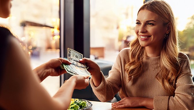 woman paying with cash
