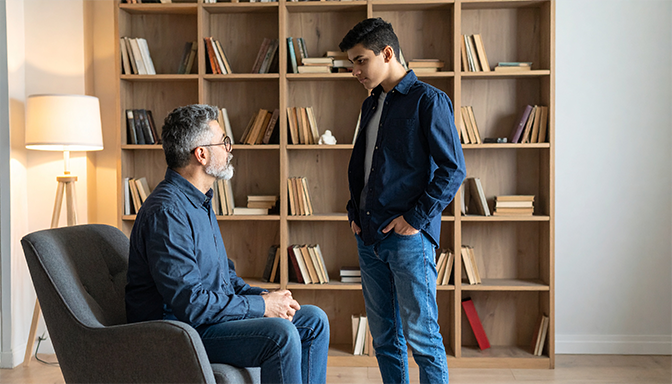 parent having boundary discussion with teenager