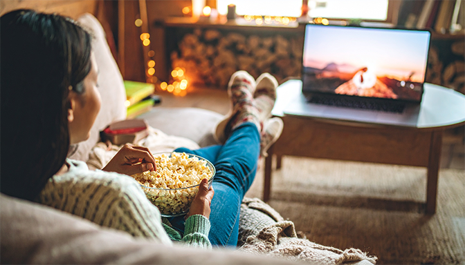person watching romantic movie on laptop