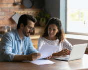 Positive Flip Home - Transform Your Relationships 11 sitting at kitchen table with financial documents