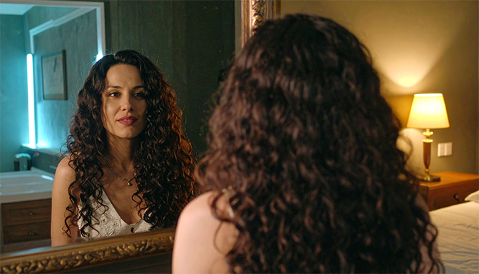 woman looking in mirror with conflicted
