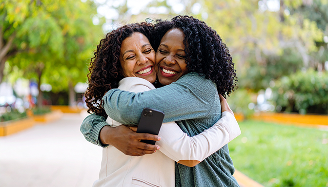 women embracing in happy reunion