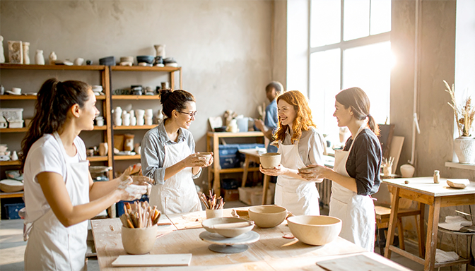 young adults in a pottery class